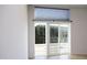 Bright room featuring sliding patio doors to a railed patio area with a view of green trees at 600 S Duke St # 26, Durham, NC 27701