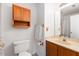 Functional bathroom with vanity, mirrored cabinet, and a white toilet at 102 Pinehill Way, Cary, NC 27513