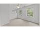 Well-lit bedroom featuring neutral carpets and two large windows at 102 Pinehill Way, Cary, NC 27513