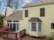Back exterior view with deck, bay window, and flowering shrubbery at 102 Pinehill Way, Cary, NC 27513