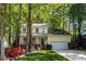 Charming yellow two-story home with a well-manicured lawn and inviting front porch and attached two car garage at 102 Pinehill Way, Cary, NC 27513