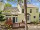 Back exterior view with deck, bay window, and flowering shrubbery at 102 Pinehill Way, Cary, NC 27513
