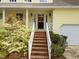Inviting front porch with white railings, brick stairs and charming address numbers for an updated look at 102 Pinehill Way, Cary, NC 27513