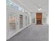 Cozy living room with a brick fireplace, large windows and doors leading to a deck at 102 Pinehill Way, Cary, NC 27513