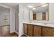 Bright bathroom featuring a double sink vanity, framed mirror, and walk-in shower, creating a functional space at 1705 Old Nc 10 Hwy, Hillsborough, NC 27278