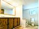 A well-lit bathroom features a double vanity, built-in bathtub, and a window for natural light and ventilation at 1705 Old Nc 10 Hwy, Hillsborough, NC 27278
