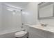 Clean, all-white bathroom with shower over tub, bright natural light, and modern white vanity at 1705 Old Nc 10 Hwy, Hillsborough, NC 27278