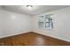 Empty bedroom with hardwood flooring, natural light, and electrical outlets around perimeter at 1705 Old Nc 10 Hwy, Hillsborough, NC 27278