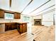Modern kitchen with light wood floors and an island open to the fireplace-centered living room at 1705 Old Nc 10 Hwy, Hillsborough, NC 27278