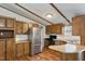Kitchen showcases stainless steel appliances, ample wood cabinet space, and a breakfast bar at 1705 Old Nc 10 Hwy, Hillsborough, NC 27278