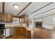 Open concept kitchen with wooden countertops and cabinets connected to a living area and fireplace at 1705 Old Nc 10 Hwy, Hillsborough, NC 27278
