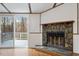 Living room with stone fireplace and sliding doors leading to outdoor deck at 1705 Old Nc 10 Hwy, Hillsborough, NC 27278