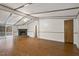 Spacious living room with a stone fireplace, hardwood floors, and sliding glass doors to the outside at 1705 Old Nc 10 Hwy, Hillsborough, NC 27278