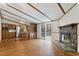 Open-concept living room shows a stone fireplace, kitchen and sliding doors to the deck at 1705 Old Nc 10 Hwy, Hillsborough, NC 27278