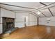 Living room with wood floors features a stone fireplace, and a ceiling fan at 1705 Old Nc 10 Hwy, Hillsborough, NC 27278