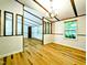 Spacious living room featuring bright wood floors and neutral walls, next to a bright kitchen at 1705 Old Nc 10 Hwy, Hillsborough, NC 27278