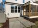 Exterior view of a home featuring a screened porch, windows, and a well-maintained concrete patio at 1804 Bright Lantern Way, Wendell, NC 27591