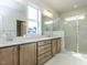 Modern bathroom featuring double vanities, quartz countertops, and a large glass shower at 1804 Bright Lantern Way, Wendell, NC 27591