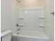 Bathroom featuring a tub-shower combo with built-in shelving and a modern faucet at 1804 Bright Lantern Way, Wendell, NC 27591