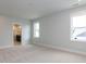 Bedroom with neutral carpet, natural light, and en-suite bathroom at 1804 Bright Lantern Way, Wendell, NC 27591