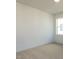 Cozy bedroom with neutral carpeting and a window bringing in natural light at 1804 Bright Lantern Way, Wendell, NC 27591