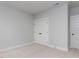 Bedroom with carpet, gray walls, and a pair of doors, with white trim at 1804 Bright Lantern Way, Wendell, NC 27591