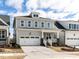 Beautiful home with gray siding, a covered porch with white railings, and an attached two-car garage at 1804 Bright Lantern Way, Wendell, NC 27591