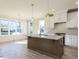 Modern kitchen featuring a center island, granite countertops, white cabinetry, and stainless steel appliances at 1804 Bright Lantern Way, Wendell, NC 27591
