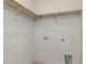 Bright laundry room with tile flooring, crisp white walls, and convenient shelving at 1804 Bright Lantern Way, Wendell, NC 27591