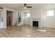 Open living space with a fireplace, hardwood floors, and seamless flow to the staircase at 1804 Bright Lantern Way, Wendell, NC 27591