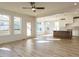 Open-concept living area with wood floors and seamless transition to kitchen and outdoor spaces at 1804 Bright Lantern Way, Wendell, NC 27591