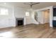 Open living room with fireplace, built-in cabinets, stairs, and neutral color palette at 1804 Bright Lantern Way, Wendell, NC 27591
