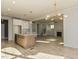 Open concept living space with kitchen island, fireplace, and wood-look floors at 1804 Bright Lantern Way, Wendell, NC 27591