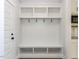 Mudroom features bench with storage, hooks and white cabinets at 1804 Bright Lantern Way, Wendell, NC 27591