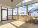 Covered patio with a wooden floor and exposed beams, leading to the backyard at 1804 Bright Lantern Way, Wendell, NC 27591