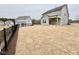 Expansive backyard with new sod, a black fence, and a covered patio on the home at 202 Steel Springs Ln # 47, Angier, NC 27501