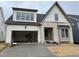 New two-story home featuring white siding, brick accents, and an attached two-car garage at 209 Big Bradley Dr, Wendell, NC 27591