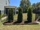 Landscaped backyard with a privacy fence and neatly trimmed shrubs at 503 Bendemeer Ln, Rolesville, NC 27571