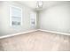 Bright bedroom with neutral carpeting and ample natural light at 503 Bendemeer Ln, Rolesville, NC 27571