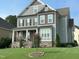 Two-story house with gray siding, stone accents, and a manicured lawn at 503 Bendemeer Ln, Rolesville, NC 27571