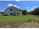 Exterior view of home's backyard with lush green lawn and treelined border at 55 New Liberty Dr, Youngsville, NC 27596