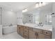 Modern bathroom with double vanity, soaking tub, and walk-in shower at 55 New Liberty Dr, Youngsville, NC 27596