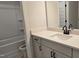 Bathroom with a white vanity, dark hardware, and a shower-tub combo at 55 New Liberty Dr, Youngsville, NC 27596