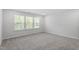 Bright bedroom featuring neutral carpet, white walls, and a window offering ample natural light at 55 New Liberty Dr, Youngsville, NC 27596