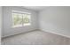 Carpeted bedroom featuring natural light from a window, and freshly painted white walls at 55 New Liberty Dr, Youngsville, NC 27596