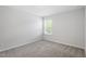 Neutral bedroom showing carpet, a window for natural light, and freshly painted white walls at 55 New Liberty Dr, Youngsville, NC 27596