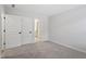 Carpeted bedroom featuring neutral carpet, white walls, and a doorway leading to the bathroom at 55 New Liberty Dr, Youngsville, NC 27596