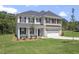 Attractive two story home with a combination brick and vinyl facade, well-manicured lawn, and attached garage at 55 New Liberty Dr, Youngsville, NC 27596