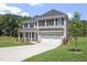 Charming two-story home featuring brick and vinyl, an attached two-car garage, and an inviting front yard at 55 New Liberty Dr, Youngsville, NC 27596