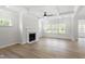 Bright living room featuring a fireplace, hardwood floors, and large windows at 55 New Liberty Dr, Youngsville, NC 27596